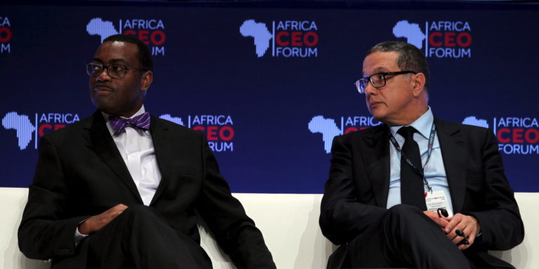 African Development Bank President Akinwumi Adesina sits with Morocco's Minister of Economy Mohamed Boussad at the Africa CEO Forum in Abidjan